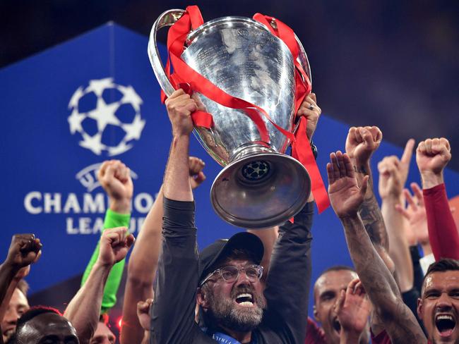(FILES) In this file photo taken on June 1, 2019 Liverpool's German manager Jurgen Klopp (C) raises the trophy after winning the UEFA Champions League final football match between Liverpool and Tottenham Hotspur at the Wanda Metropolitano Stadium in Madrid. - Twelve of Europe's most powerful clubs announced the launch of a breakaway European Super League on April 19, 2021 in a potentially seismic shift in the way football is run, but faced accusations of greed and cynicism. Six Premier League teams, Liverpool, Manchester United, Arsenal, Chelsea, Manchester City and Tottenham are involved, alongside Real Madrid, Barcelona, Atletico Madrid, Juventus, Inter Milan and AC Milan. Real Madrid chief Florentino Perez, who was announced as the first ESL president, said the breakaway reflected the big clubs' wishes. (Photo by Ben STANSALL / AFP)