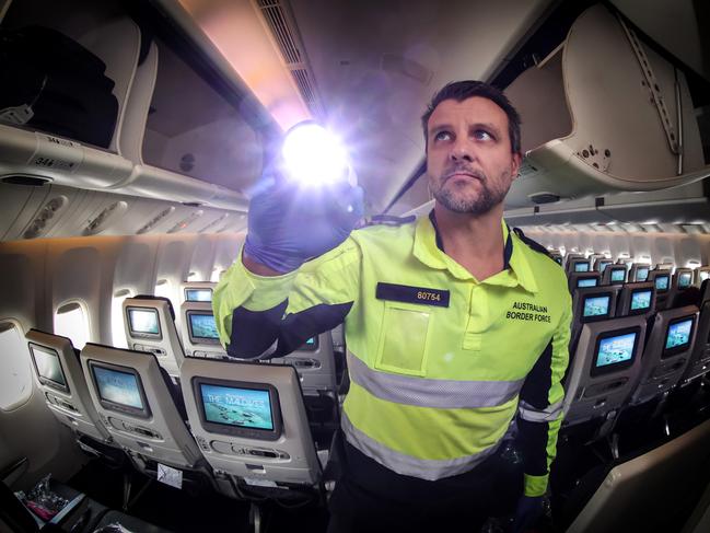 Exclusive BTS of Border Force's Operation Jet Engine which searches planes and cargo at the airport for drugs and other illegal goods. ABF Air Border Security officer checks the cabin of an international passenger plane at Melbourne Airport.                     Picture: David Caird