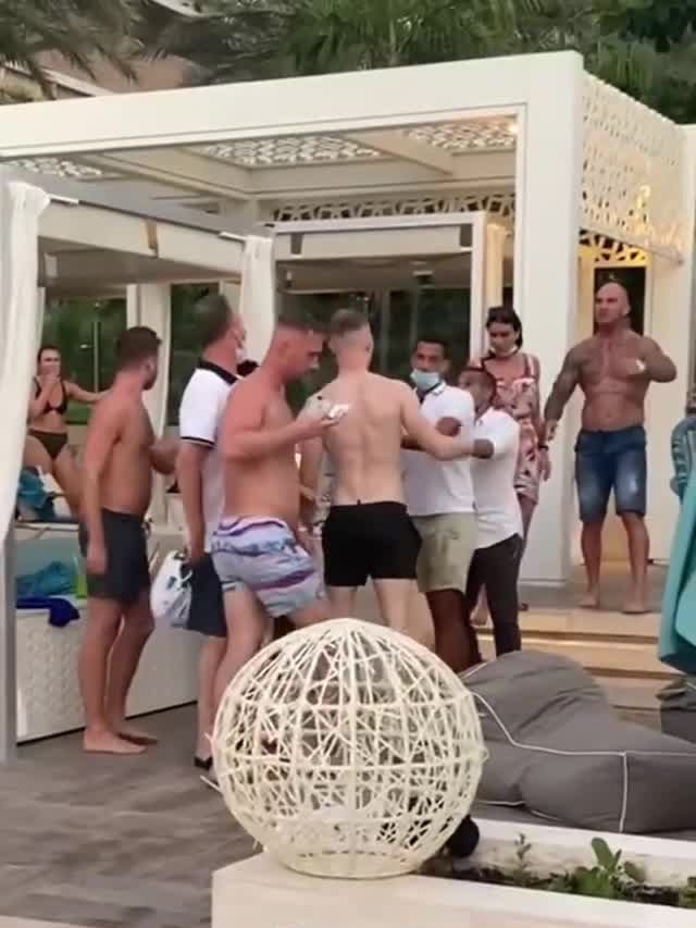 The exiled bikie boss Mark Buddle (Bald, shirtless, tattoos) was involved in a scuffle with a group of British tourists at an upmarket beach restaurant in Dubai.
