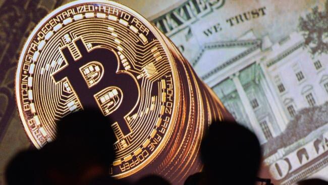 Bitcoin and US currencies displayed at a conference in Singapore. Pic: AFP