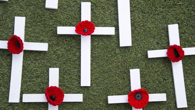 Ex-police officer Lisa Hewitt is making 500 wooden crosses with knitted poppies to give to people to put at the end of their driveways this Anzac Day. Picture: AAP/Troy Snook