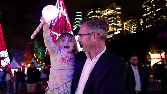 Former NSW Premier Dominic Perrottet looking at the fireworks with his daughter Beatrice during a visit with his wife Helen and their children to the Noel Christmas markets at the Royal Botanic Garden Sydney last year. Picture: Jonathan Ng