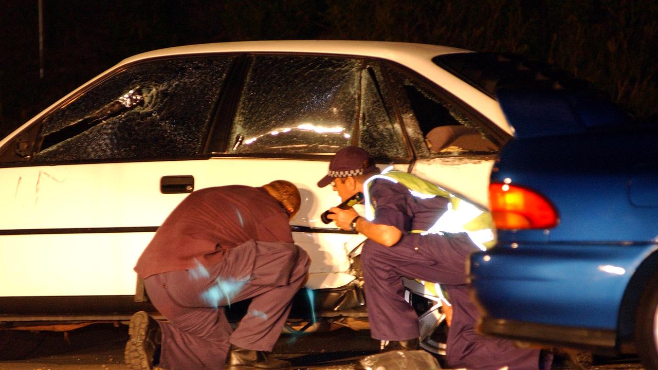 Police inspect the car of the victim at stabbing scene at the Currimundi Market Place in 2004.