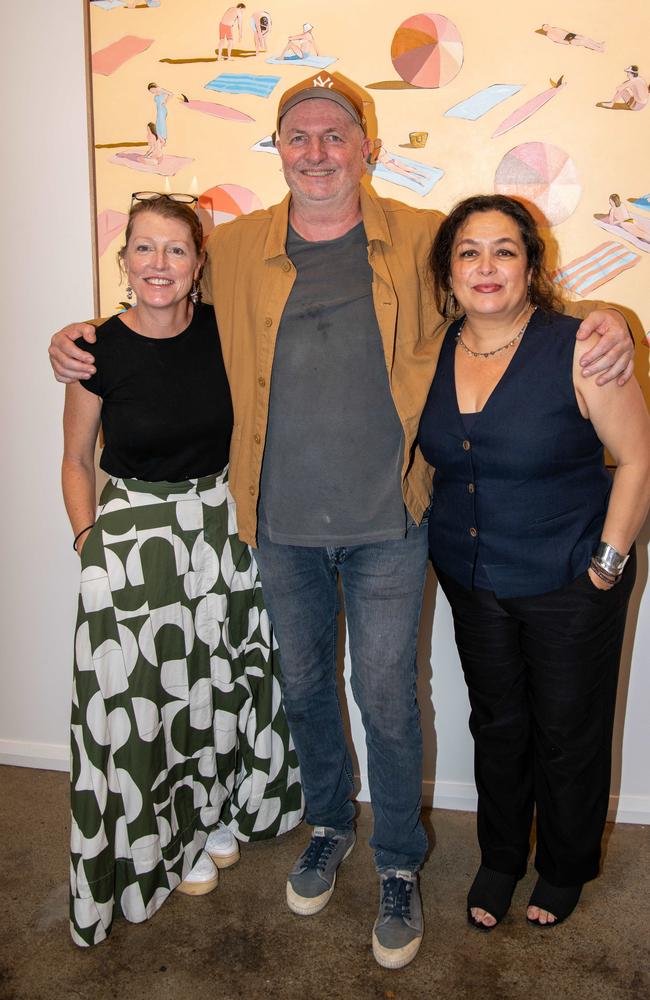 Directors of the Sydney Road Gallery, Fiona Chandler and Marilou Palazon with Mitchell English at the opening of the "Mirror Maze" solo exhibition on Saturday. Picture: Thomas Lisson