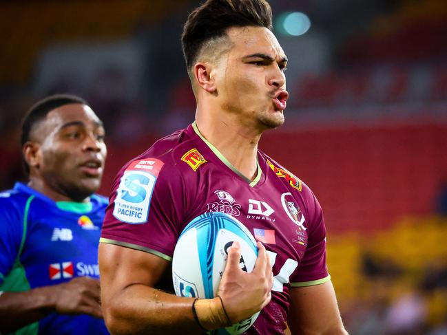 Queensland Reds Jordan Petaia splits the Fiji Drua's defence during the Super Rugby match between the Queensland Reds and Fijian Drua at Suncorp Stadium in Brisbane on March 12, 2022. (Photo by Patrick HAMILTON / AFP) / -- IMAGE RESTRICTED TO EDITORIAL USE - STRICTLY NO COMMERCIAL USE --