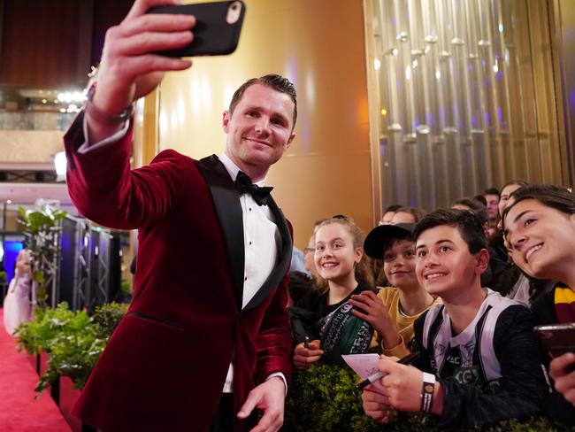 Patrick Dangerfield of the Cats takes a selfie with fans on the red carpet at the 2019 Brownlow Medal ceremony at the Crown Palladium in Melbourne, Monday, September 23, 2019. The Brownlow medal is awarded to the the AFL's best and fairest player.  (AAP Image/Michael Dodge) NO ARCHIVING, EDITORIAL USE ONLY