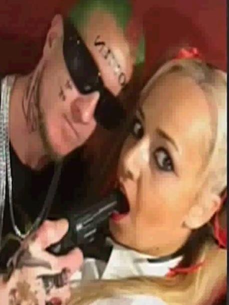 Dale Ewins, 35, and Zita Sukys, 37, pose with what appears to be a toy gun. Picture: Seven News