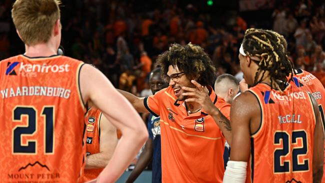 Injured Taipan Keanu Pinder celebrates with teammates after the win. (Photo by Emily Barker/Getty Images)