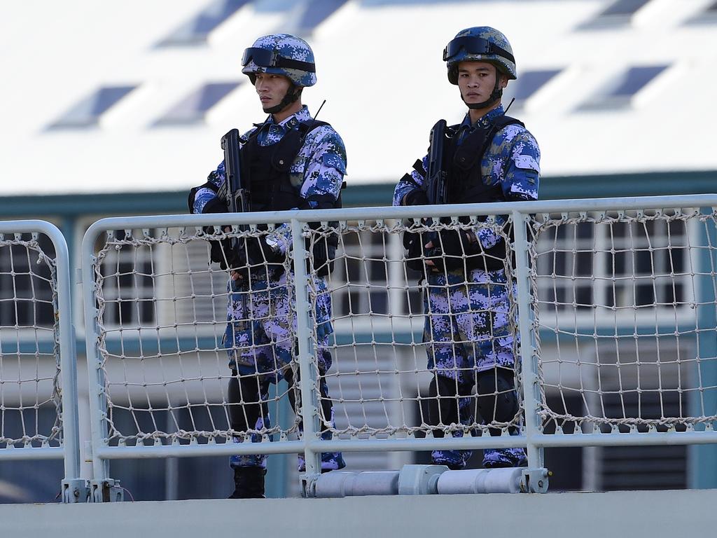 Making their presence felt ... heavily armed Chinese Navy personnel onboard a Chinese Navel ship after it arrives at Garden Island Naval Base in Sydney. Picture: AAP