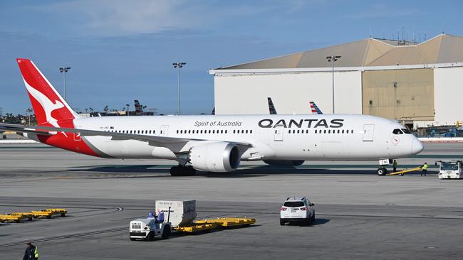 Qantas has a new “no jab no fly” rule. (Photo by Daniel SLIM / AFP)