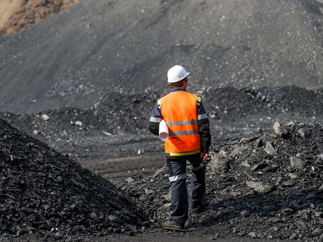 Coal mining in an open pit - Worker is looking on the huge open pit