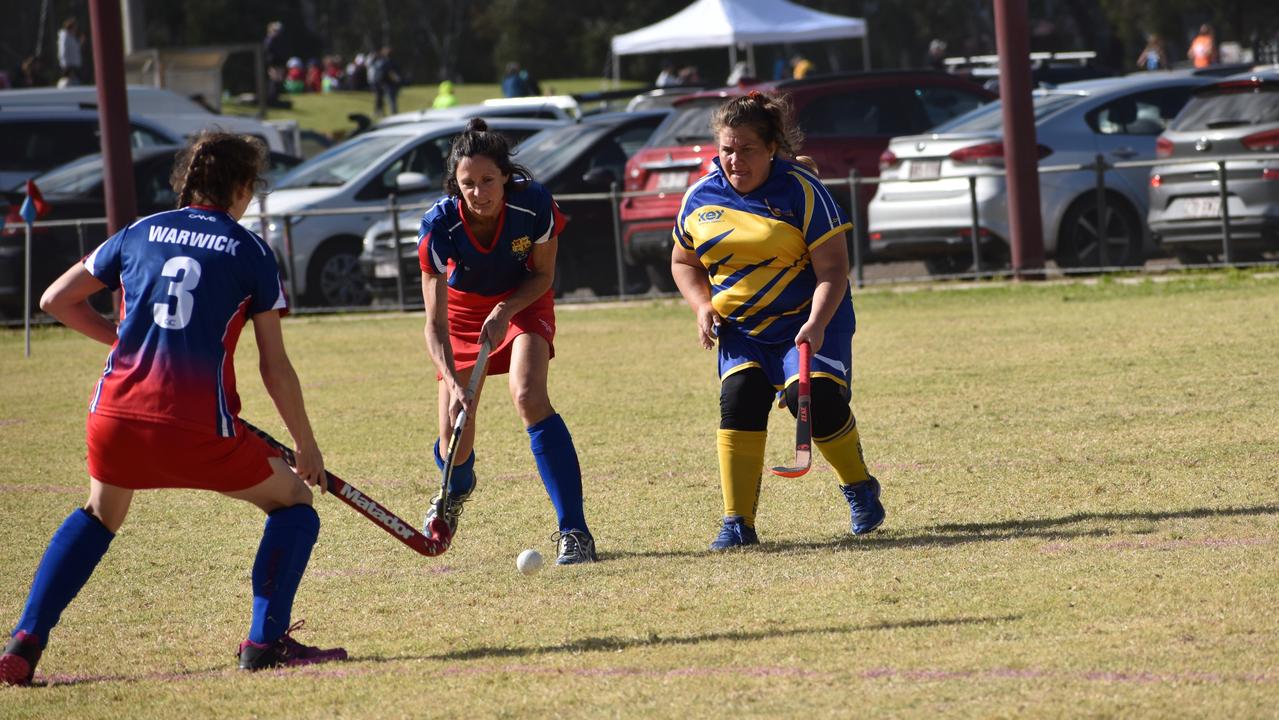 Karina Miles (3) and Sarah Dudin for Warwick compete against Townsville's Dulcie Reilly at the 2021 Queensland Hockey Women's Masters Championship at Queens Park.