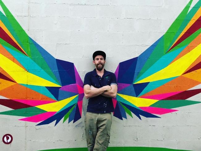 Artist Paul Sonsie with his Pride Cup mural in Yarra Glen.