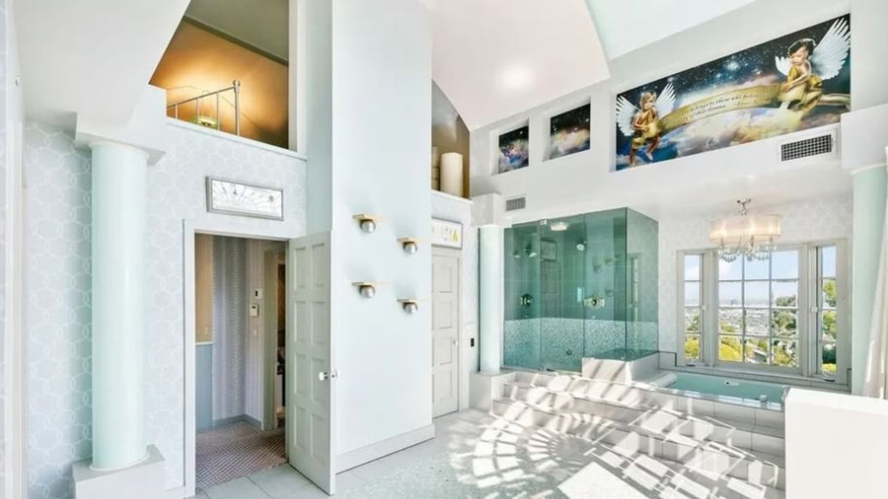 The cherubic artwork can also be found in the primary bathroom. Picture: Realtor.