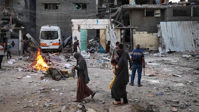 Palestinians amid the rubble of a family house that was hit overnight in Israeli bombardment in the Tal al-Sultan neighbourhood of Rafah in southern Gaza on May 20. Picture: AFP