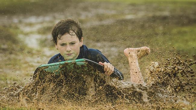 Banny Gregory, 12, makes the most of muddy conditions. Picture: NewsWire/ Glenn Campbell