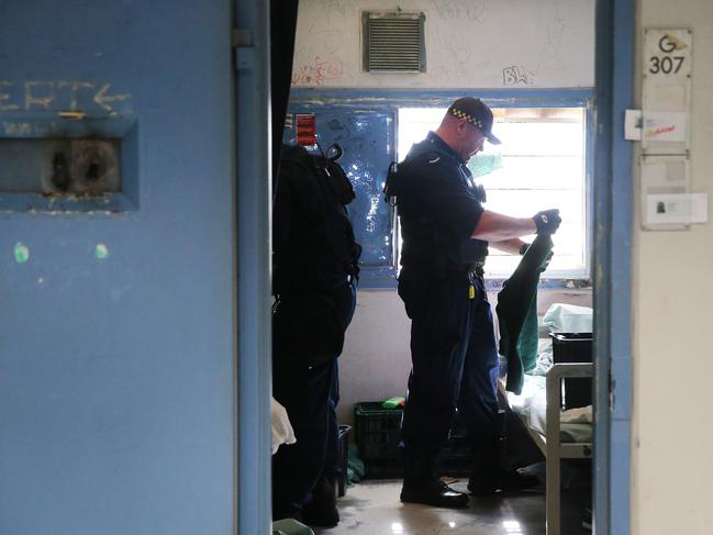 Corrective Services officers raid cells at Silverwater Jail looking for contraband. The officers now wear body cams that record the raids. Picture: Richard Dobson