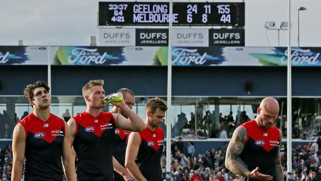 Melbourne players walk off Simonds Stadium after losing to Geelong. Picture: Colleen Petch