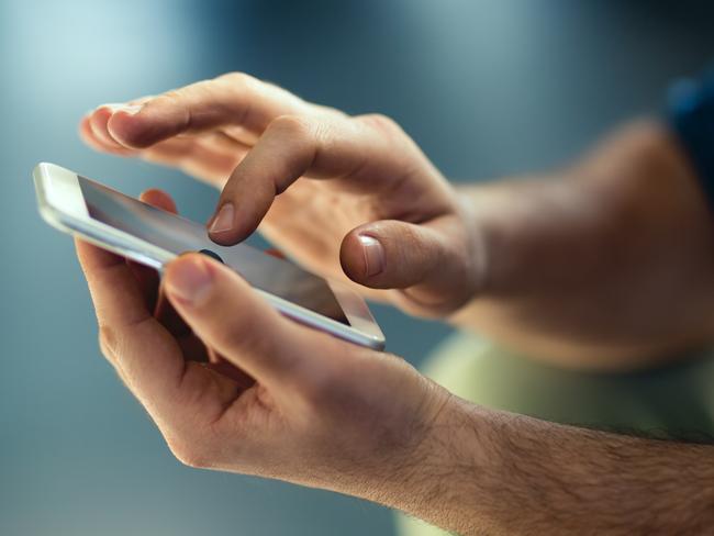 Generic Male hands typing on smartphone. Picture: Istock