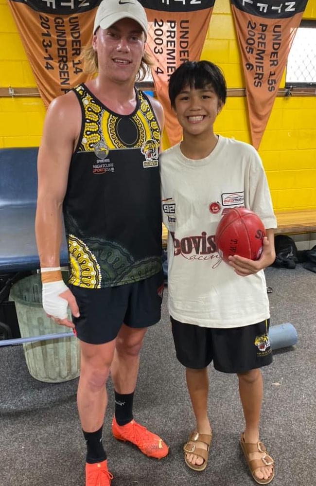 Harley Reid (left) in his new Nightcliff Tigers kit, posing with a fan in the sheds. Picture: Nightcliff Tigers Football Club Facebook.