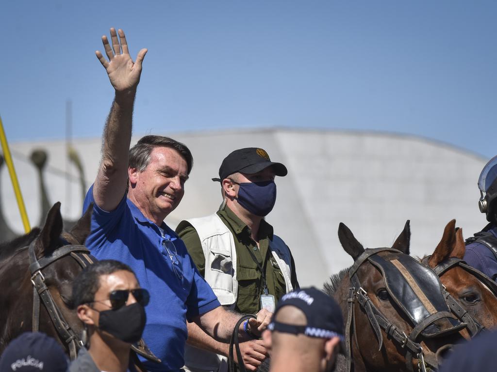 Brazil’s President Jair Bolsonaro greets supporters outside the presidential palace in Brasilia last month. Picture: Andre Borges
