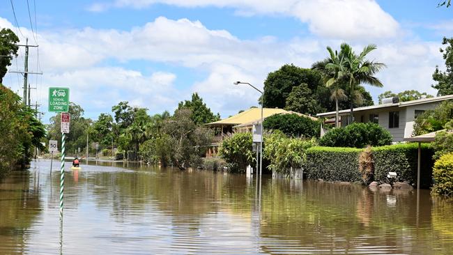 BRISBANE, AUSTRALIA - MARCH 01: A girl is seen paddling up Cliveden St in Corinda on March 01, 2022 in Brisbane, Australia. Over 15,000 are predicted to be flood-damaged after the Brisbane River peaked at 3.85 metres. (Photo by Bradley Kanaris/Getty Images)