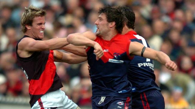 Andrew Welsh clashes with Russell Robertson and Brad Miller during the 2004 elimination final.