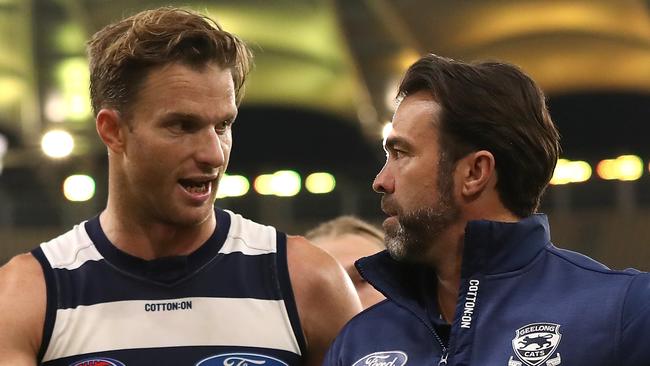 PERTH, AUSTRALIA - AUGUST 01: Lachie Henderson of the Cats talks with Chris Scott, head coach while walking from the field after being defeated during the round nine AFL match between West Coast Eagles and the Geelong Cats at Optus Stadium on August 01, 2020 in Perth, Australia. (Photo by Paul Kane/Getty Images)