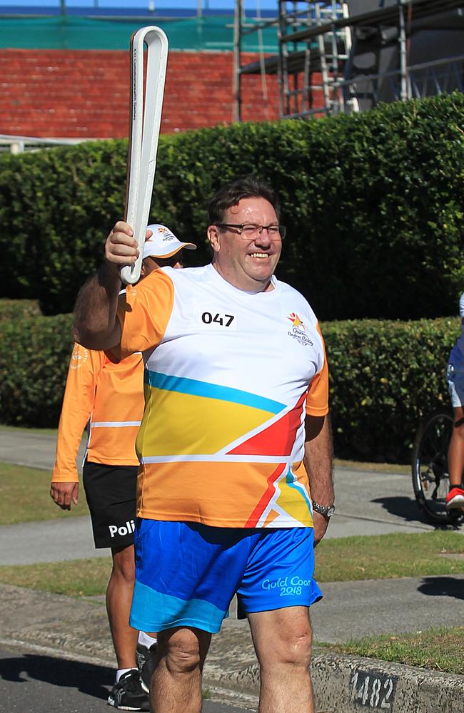 David Morrow carrying the baton in the Queens Baton Relay ahead of the 2018 Commonwealth Games. Picture: AAP IMAGE
