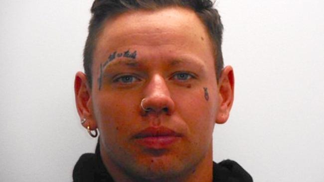 Cooper’s mugshot shows his face tattoo with the words: “Dead men tell no tails”. Picture: Victoria Police