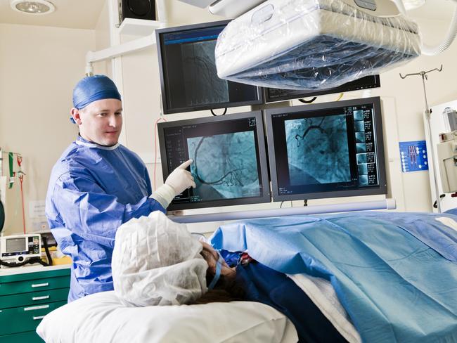 Cathlab in modern hospital with doctor and patient