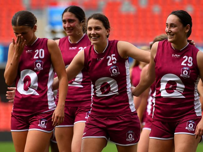 Mia Salisbury, Kiara Bischa and Ella Calleja of Queensland celebrate victory during the AFL National Championships (Photo by Albert Perez/AFL Photos via Getty Images)