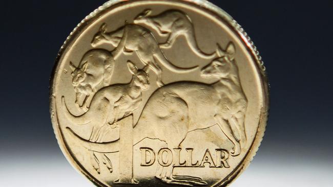 An Australian one-dollar coin is arranged for a photograph in Sydney, Australia, on Wednesday, April 17, 2013. Direct trading between the Australian dollar and yuan started on April 10. Photographer: Ian Waldie/Bloomberg