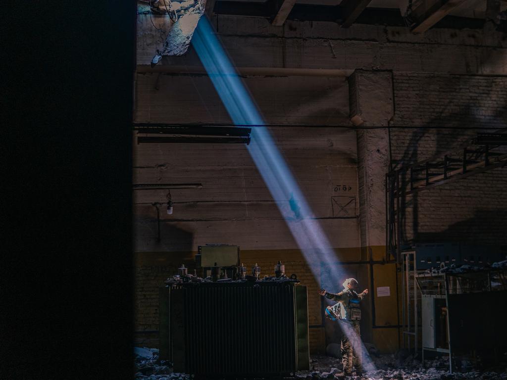 A soldier is seen standing under a ray of light inside the steelworks. Picture: Dmytro Kozatsky