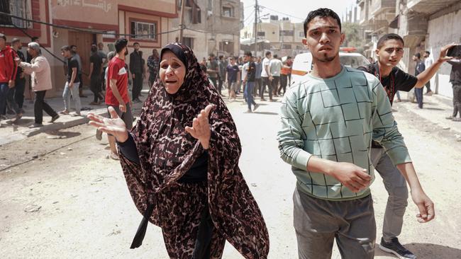 Palestinians react to an Israeli strike on al-Bureij camp in the central Gaza Strip. Picture: AFP