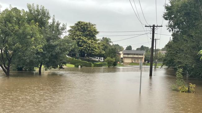 Flooding at Belgenny Reserve laps driveways on Belgenny Ave. Picture taken on March 8, 2022.