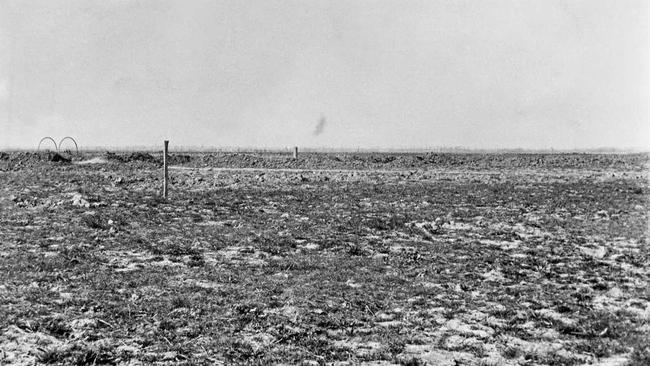 In the distance, across a flat landscape, smoke rises from a shell exploding at Bullecourt. Picture: Australian War Memorial (P02321.