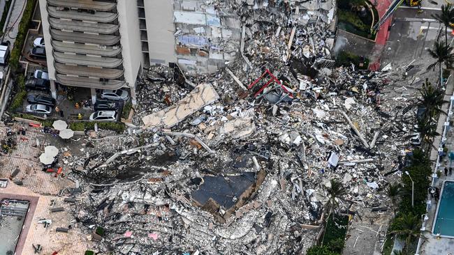 This aerial view, shows search and rescue personnel working on site after the partial collapse of the Champlain Towers South in Surfside, north of Miami Beach.