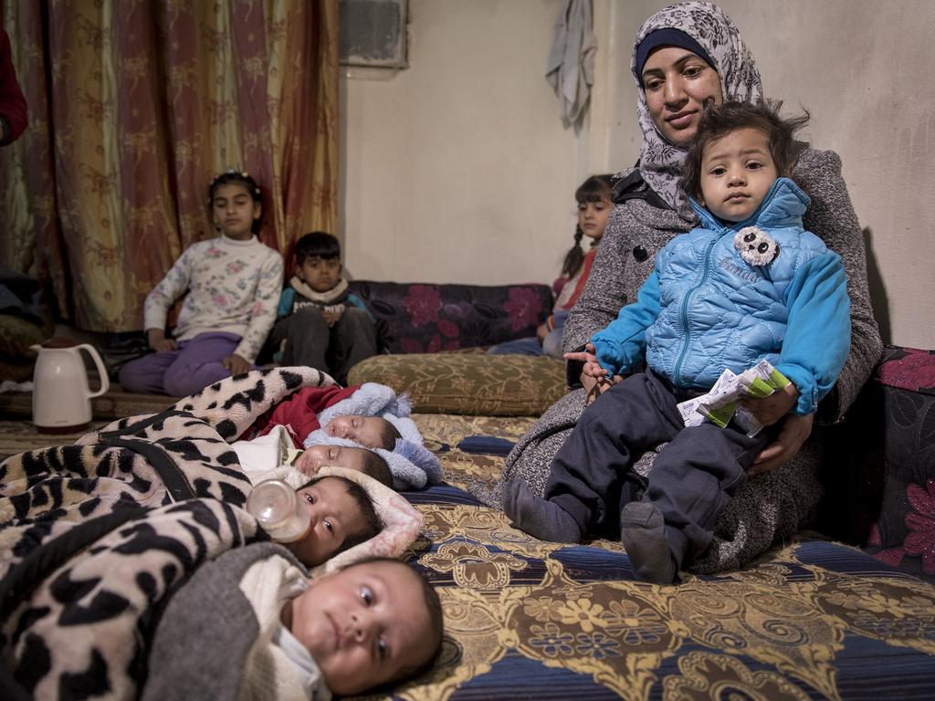 Mother of quadruplets Elham Ali, 33, in Deir ez Zor with her daughter Marah, 18 months, and babies from (left) Farah, Ataa, Sharoq and Abdullah. Picture: Ella Pellegrini