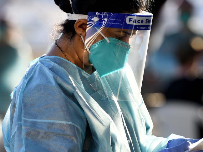 SYDNEY, AUSTRALIA - NCA NewsWire Photos JULY, 29, 2020: NSW Health workers dressed in Protection Equipment (PPE) are seen at the Rushcutters Bay popup COVID-19 (Coronavirus) testing site in Sydney. A pop-up COVID-19 testing clinic in Rushcutters Bay Park has been established following the closure of the yacht club due after two visitors testing positive.Two people who dined at Thai Rock and the Apollo in Potts Point also visited the Cruising Yacht Club of Australia three times over July 23, 24 and 26. Picture: NCA NewsWire / Bianca De Marchi