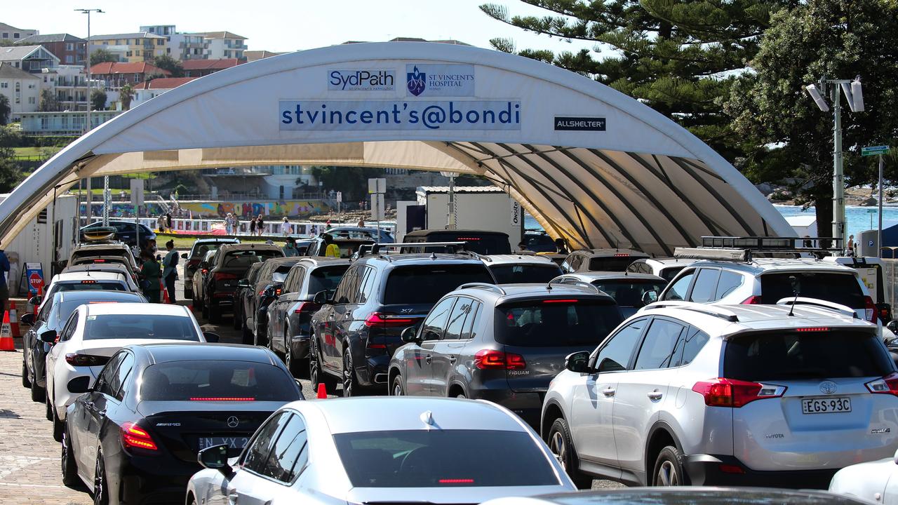 Health experts say a rapid test is the best first step if you’re experiencing symptoms, with anyone returning a positive result then urged to line up for a PCR test (queue in Sydney pictured). Picture: NCA NewsWire / Gaye Gerard