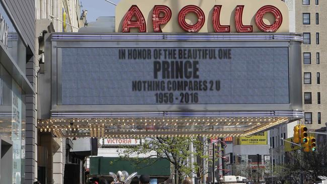 Pedestrians pass the Apollo Theater in New York. Picture: AP