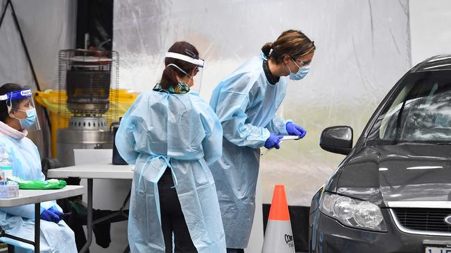 Medical staff prepare to take a swab at a drive-through testing clinic in Melbourne. Picture: AFP