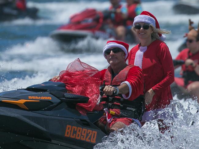 More than 150 people in Santa suits board jet skis to attempt a Guinness World Record and raise money for charity.Picture: Glenn Campbell