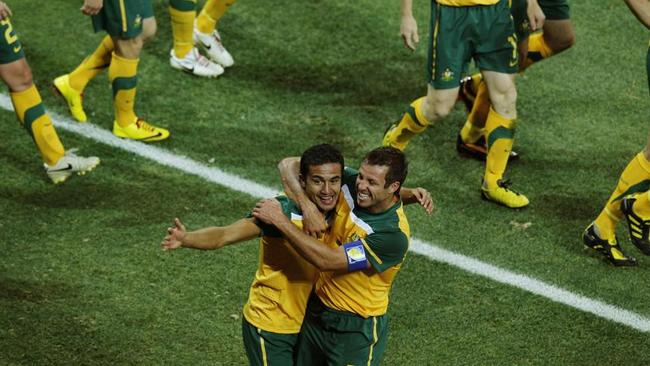 Australia's Lucas Neill celebrates Tim Cahill’s goal against Serbia.