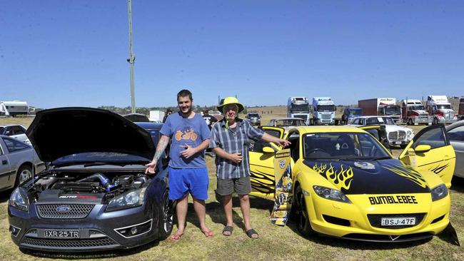 Aaron Cassie with his father Grant Cassie battle it out over which car is better. Picture: Tim Jarrett