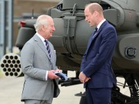 STOCKBRIDGE, HAMPSHIRE - MAY 13: King Charles III and Prince William, Prince of Wales stand in front of an Apache helicopter during the official handover in which King Charles III passes the role of Colonel-in-Chief of the Army air corps to Prince William, Prince of Wales at the Army Aviation Centre on May 13, 2024 in Stockbridge, Hampshire. (Photo by Chris Jackson/Getty Images)