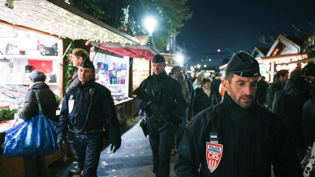 French policemen of the CRS company patrol in Strasbourg, eastern France, on November 23, 2018, on the opening day of the city's Christmas market, the largest and one of the oldest Christmas markets in France. (Photo by SEBASTIEN BOZON / AFP)