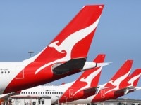 SYDNEY, AUSTRALIA - AUGUST 18: The tail fins of Qantas aircraft parked at Sydney's Kingsford Smith International Airport on August 18, 2021 in Sydney, Australia. Qantas Group has announced COVID-19 vaccinations will be mandatory for all 22,000 staff members. Frontline employees Ã¢â¬â including cabin crew, pilots and airport workers Ã¢â¬â will need to be fully vaccinated by November 15 and the remainder of employees by March 31. There will be exemptions for those who are unable to be vaccinated for documented medical reasons, which is expected to be very rare. (Photo by James D. Morgan/Getty Images)