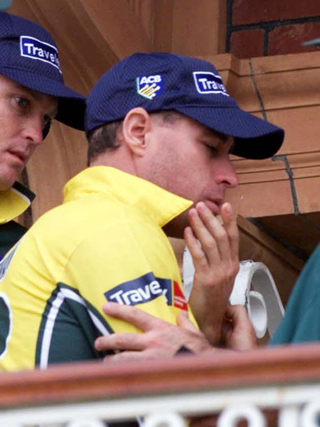 Australian cricketer Michael Bevan holding a hand to his face after being hit with a beer can missile thrown from crowd during presentation at Lords in Jun 2001.